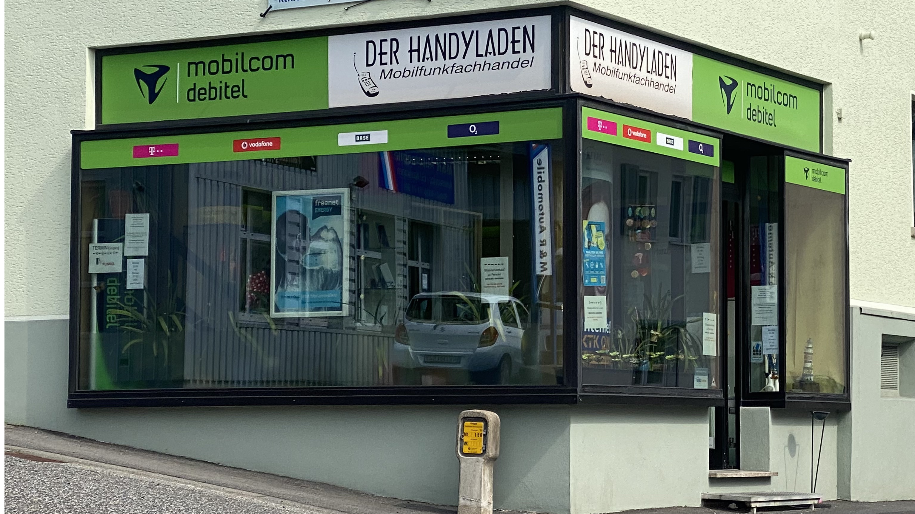 Der Handyladen – ein Mobilfunkfachhandel mit Marken wie mobilcom debitel, T-Mobile, Vodafone und O2 – zeigt die storefront eines lokalen Unternehmens, das zum Gewerbeverein Westerburg gehört und die regionale Wirtschaft stärkt.